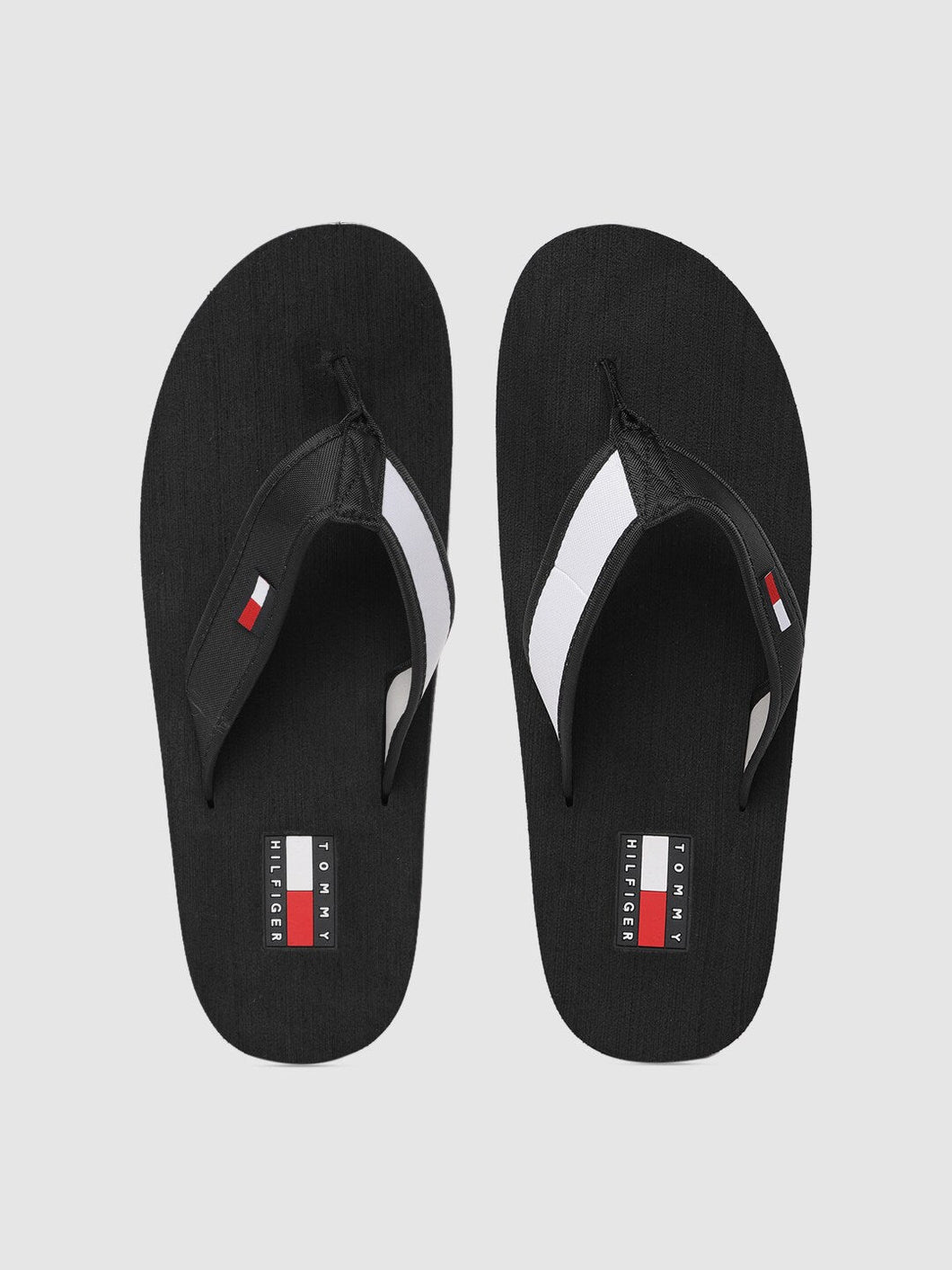 7b1083c5-ab20-43af-96d4-c5c3519652be1568632351328-Tommy-Hilfiger-Men-Black-White-Colourblocked-Slip-On-598156-1.jpg